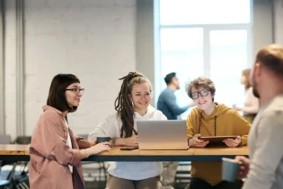 Group of people meeting around a table.