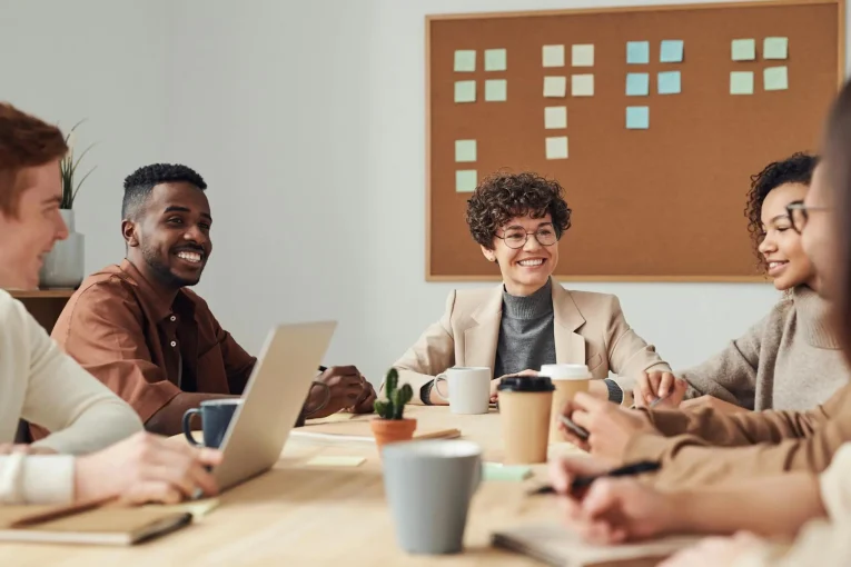 Colleagues collaborating around a meeting table.