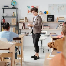 Teacher presenting to students in a classroom.