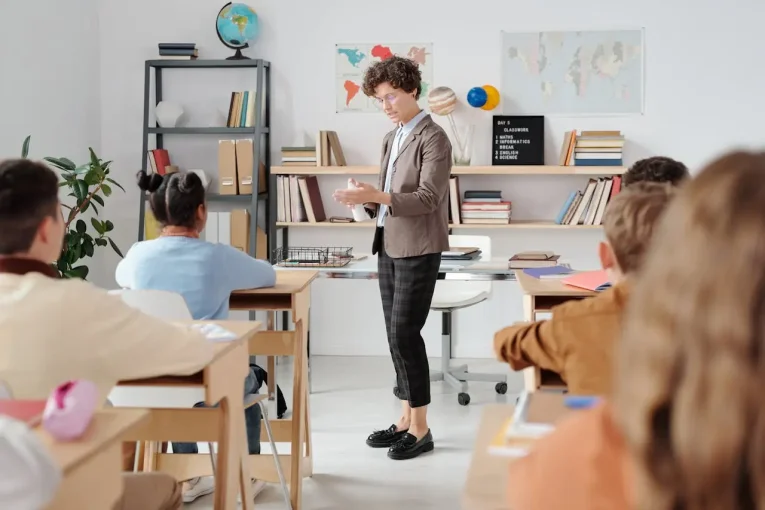 Teacher presenting to students in a classroom.